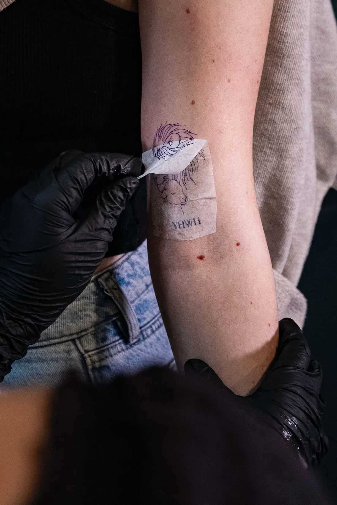 peeling lion and lamb yhwh tattoo stencil off of arm
